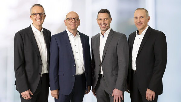 Chief technical officer, Maik Schmees; Board, Dirk Dingfelder; Board, Christoph Kern and Chief financial officer, Mirko Matenia  stands next to each other and smile